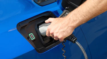 Person connecting charger to Vauxhall Astra Electric