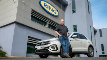 Auto Express products editor Kim Adams leaning against our long-term Volkswagen T-Roc
