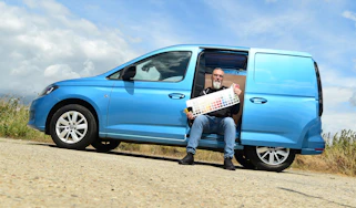 Auto Express senior test editor Dean Gibson sitting in the side of our long-term Volkswagen Caddy Cargo