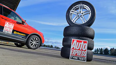 Stack of tyres next to a Volkswagen Tiguan