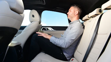 Auto Express deputy editor Richard Ingram sitting in the back seat of the BMW i4 eDrive35 M Sport