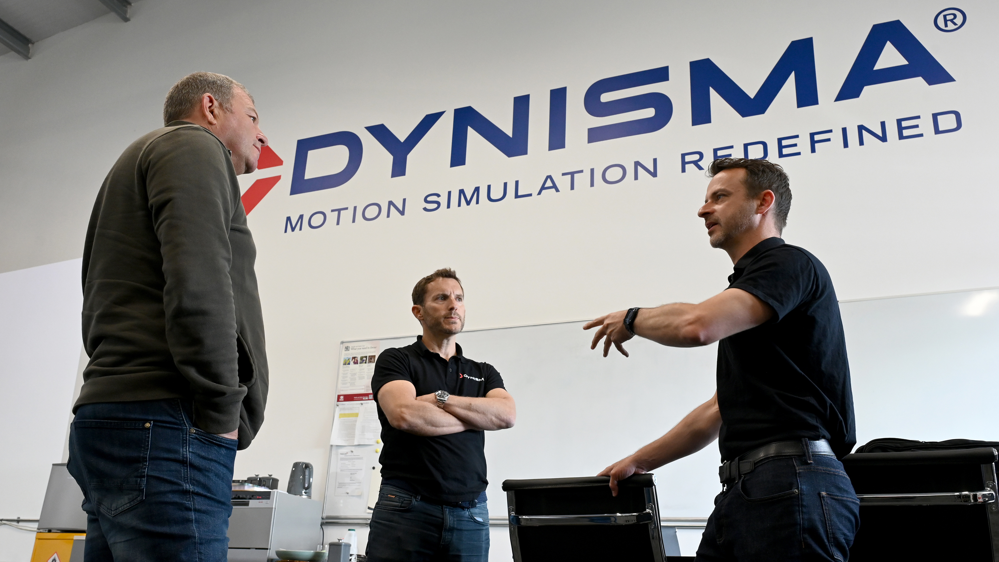 Dynisma staff discussing simulator with Steve Sutcliffe