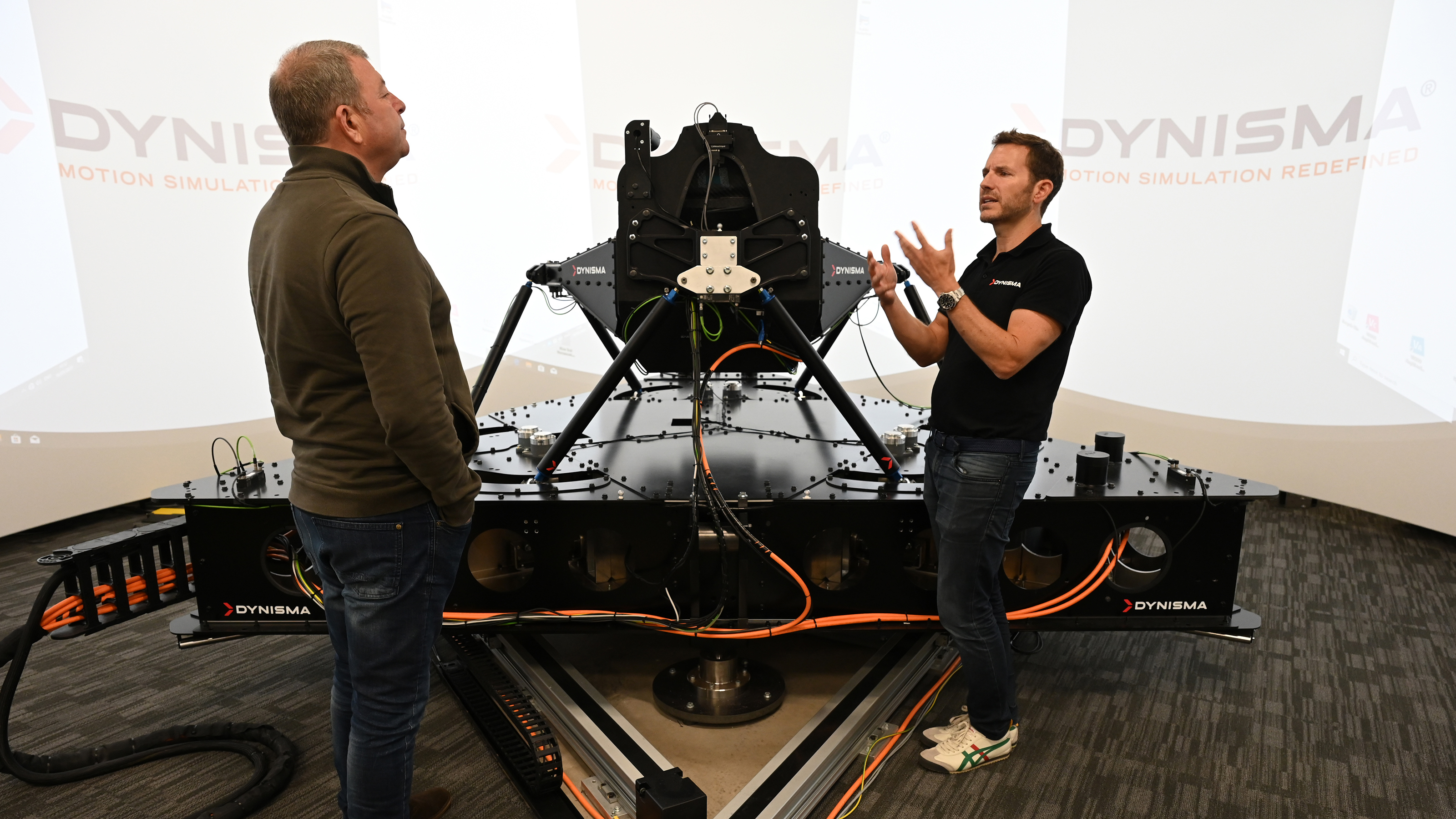 Steve Sutcliffe standing next to the the Dynisma driving simulator