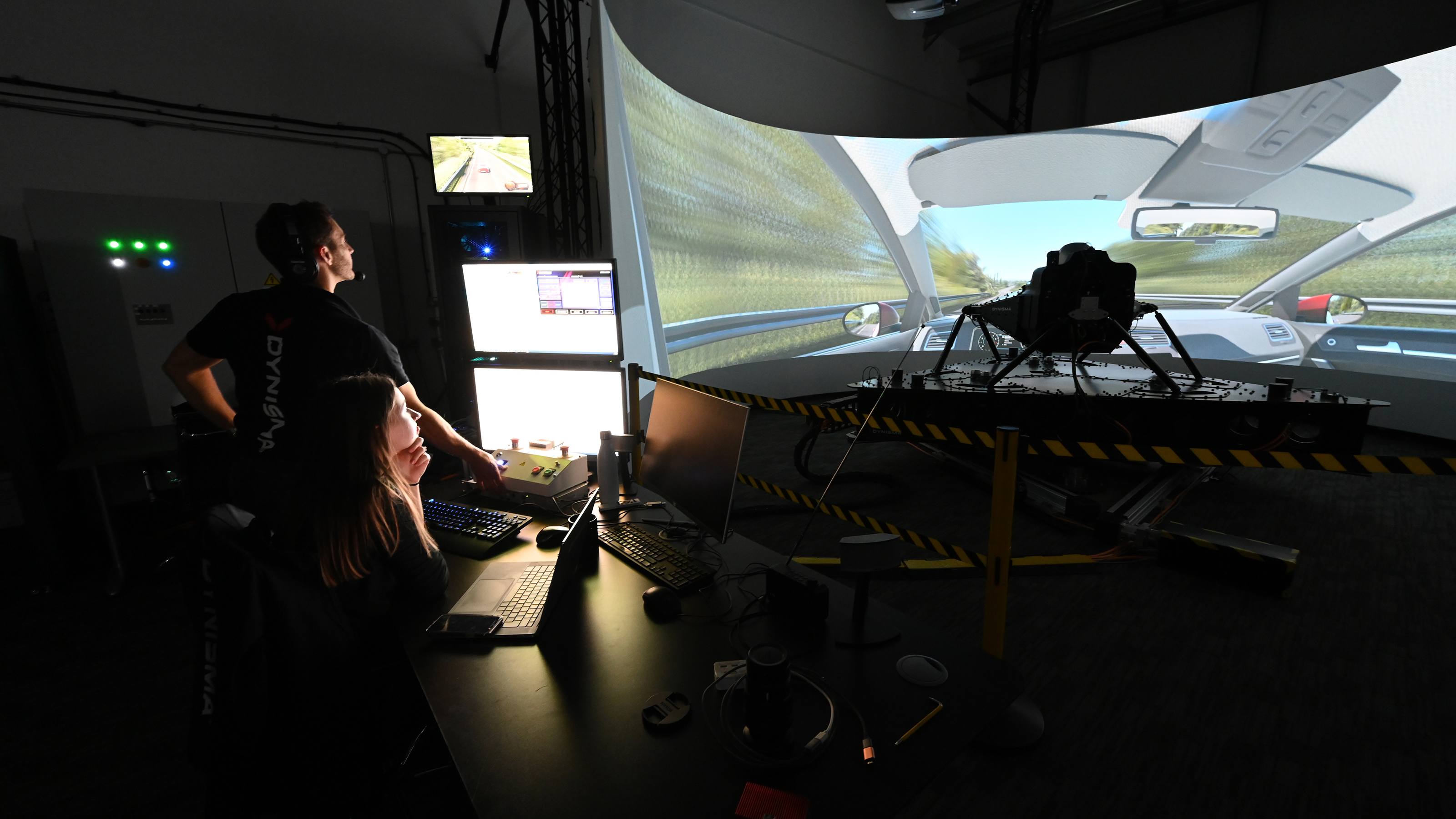 Dynisma team observing Steve Sutcliffe in the Steve Sutcliffe driving in the Dynisma driving simulator