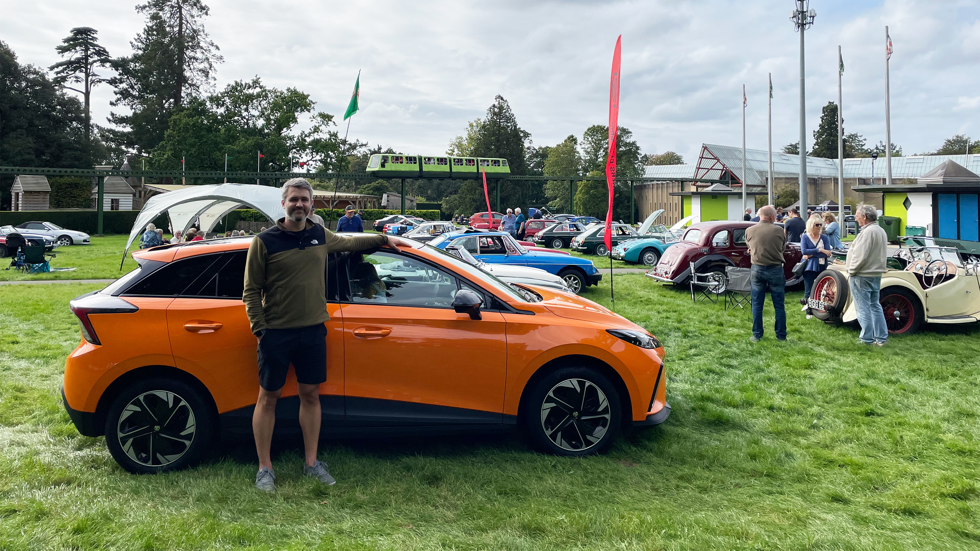 Auto Express deputy editor Richard Ingram standing with the MG4 Trophy Long Range at an MG event at Beaulieu