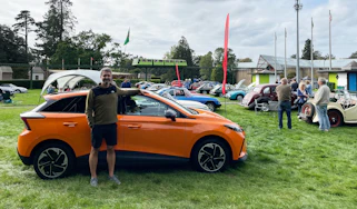 Auto Express deputy editor Richard Ingram standing with the MG4 Trophy Long Range at an MG event at Beaulieu