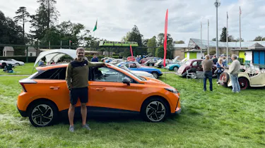 Auto Express deputy editor Richard Ingram standing with the MG4 Trophy Long Range at an MG event at Beaulieu