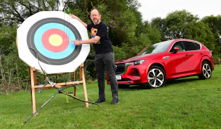 Auto Express chief sub-editor Andy Pringle standing next to an archery target