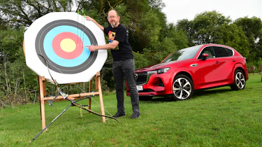 Auto Express chief sub-editor Andy Pringle standing next to an archery target