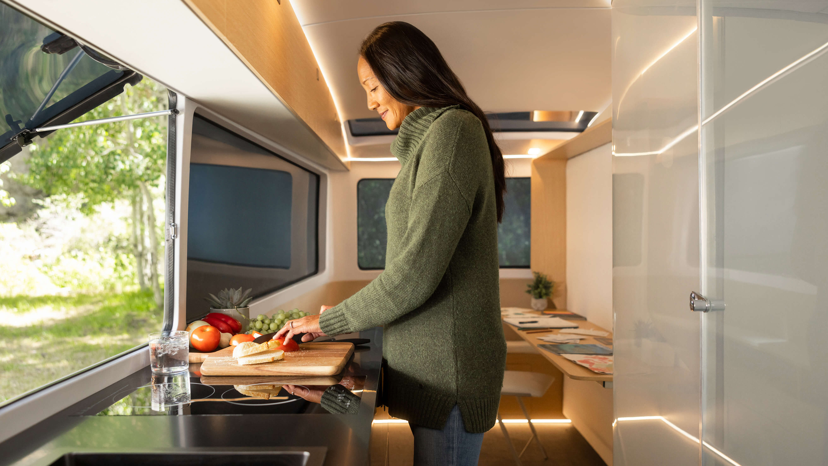 Person using the Pebble Flow caravan's kitchen
