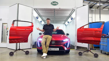 Auto Express head of digital content Steve Walker standing with the Peugeot 408 in a body repair shop