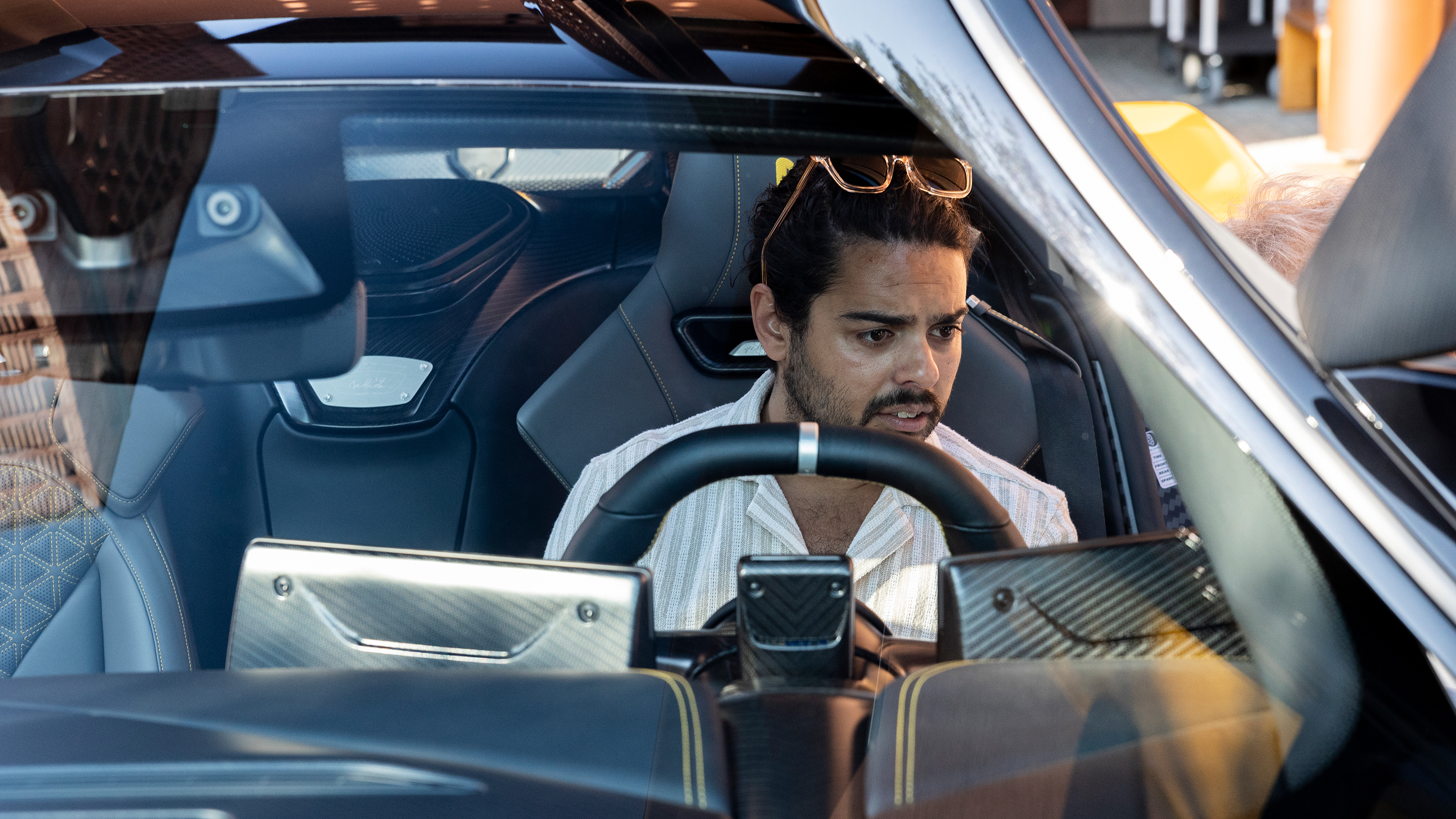 Auto Express senior staff writer Jordan Katsianis inspecting the Pininfarina Battista's interior