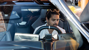 Auto Express senior staff writer Jordan Katsianis inspecting the Pininfarina Battista's interior