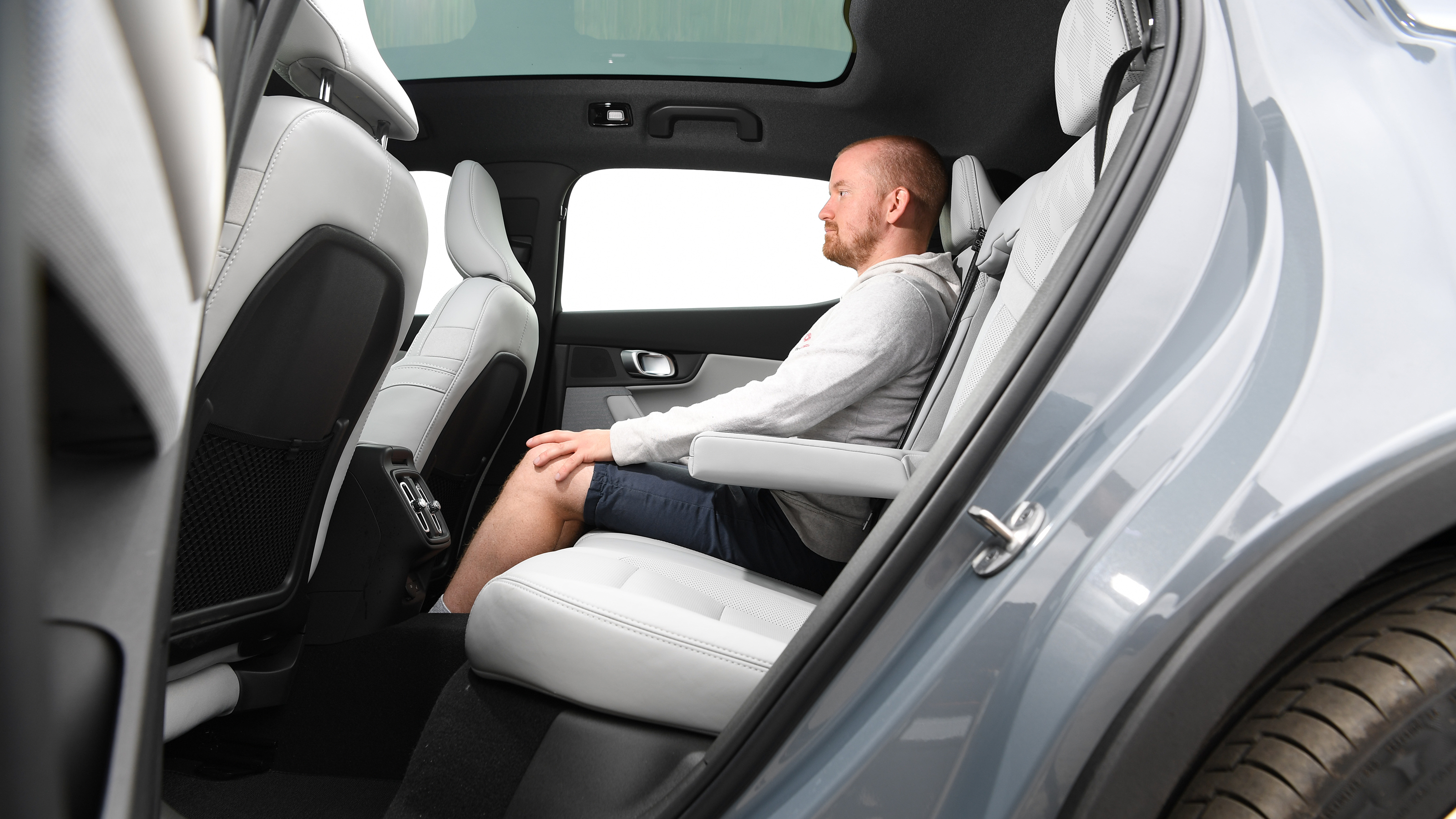 Auto Express chief reviewer Alex Ingram sitting in the Polestar 2's rear seats