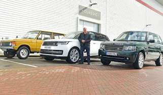 Auto Express editor-in-chief Steve Fowler standing with multiple generations of Range Rover