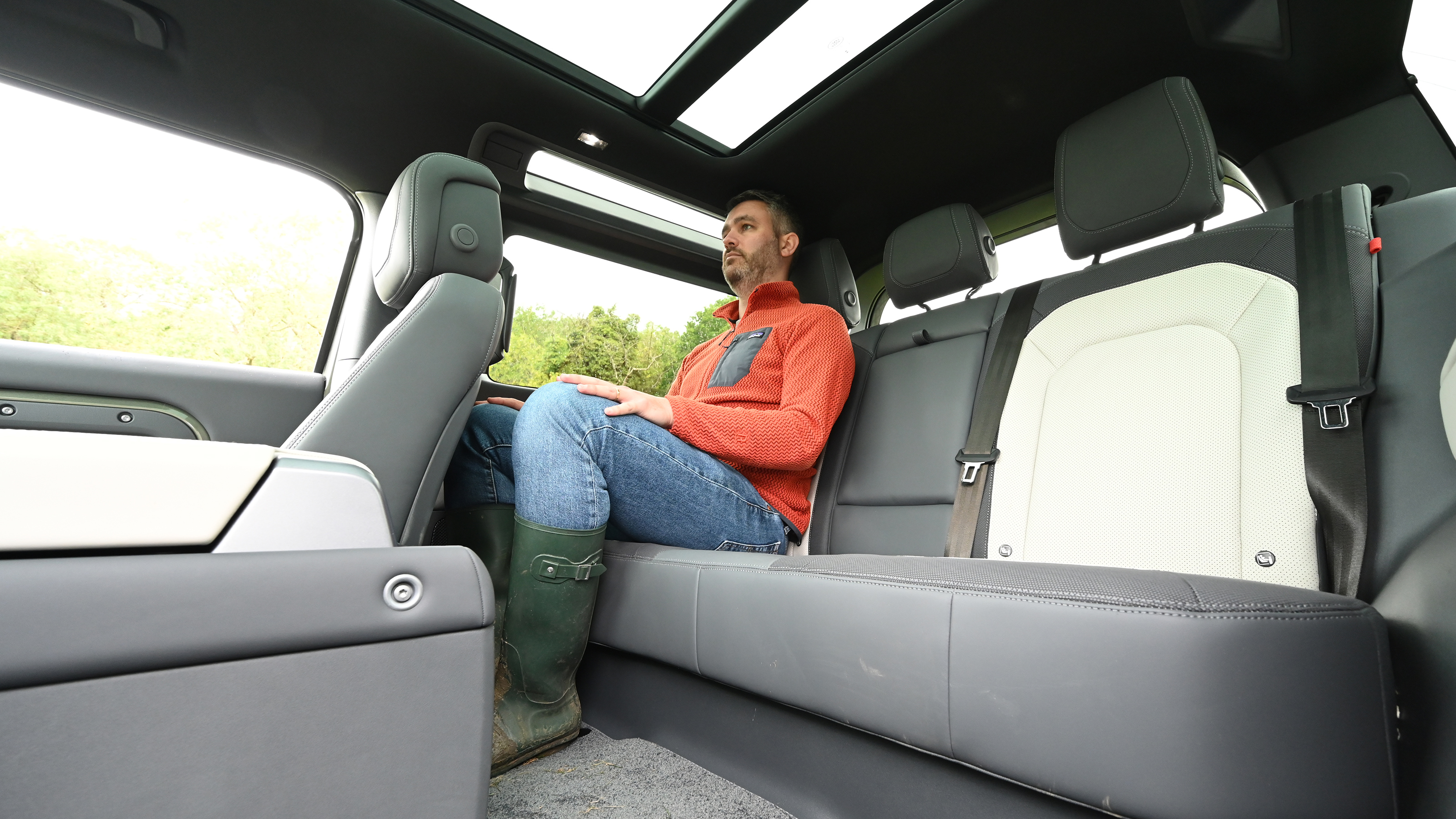 Auto Express deputy editor Richard Ingram sitting in the back seat of the Land Rover Defender
