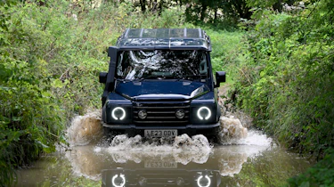 Ineos Grenadier driving through a ford