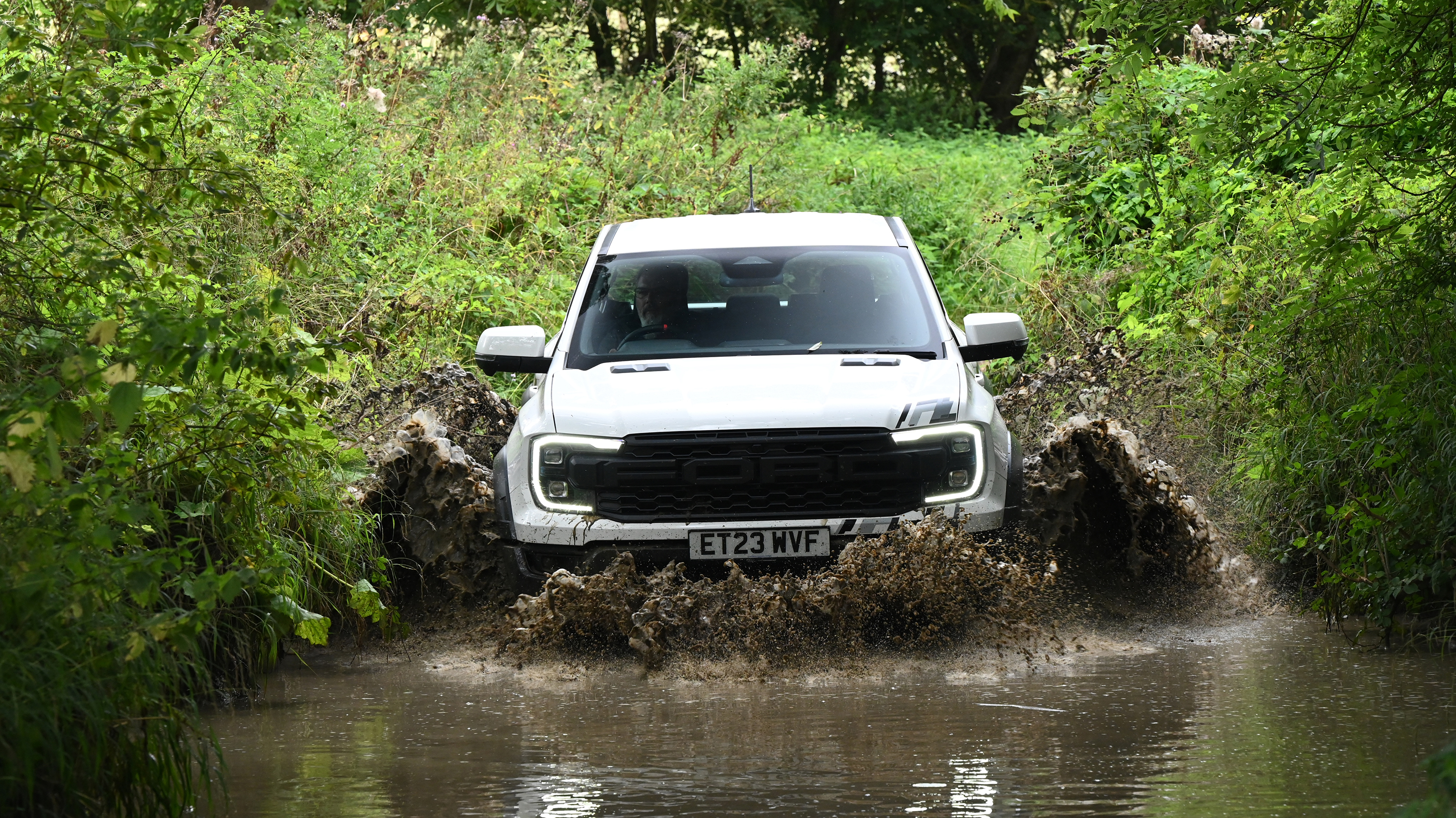 Ford Ranger Raptor driving through a ford