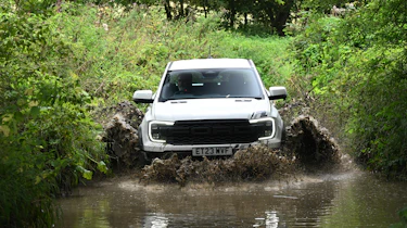 Ford Ranger Raptor driving through a ford