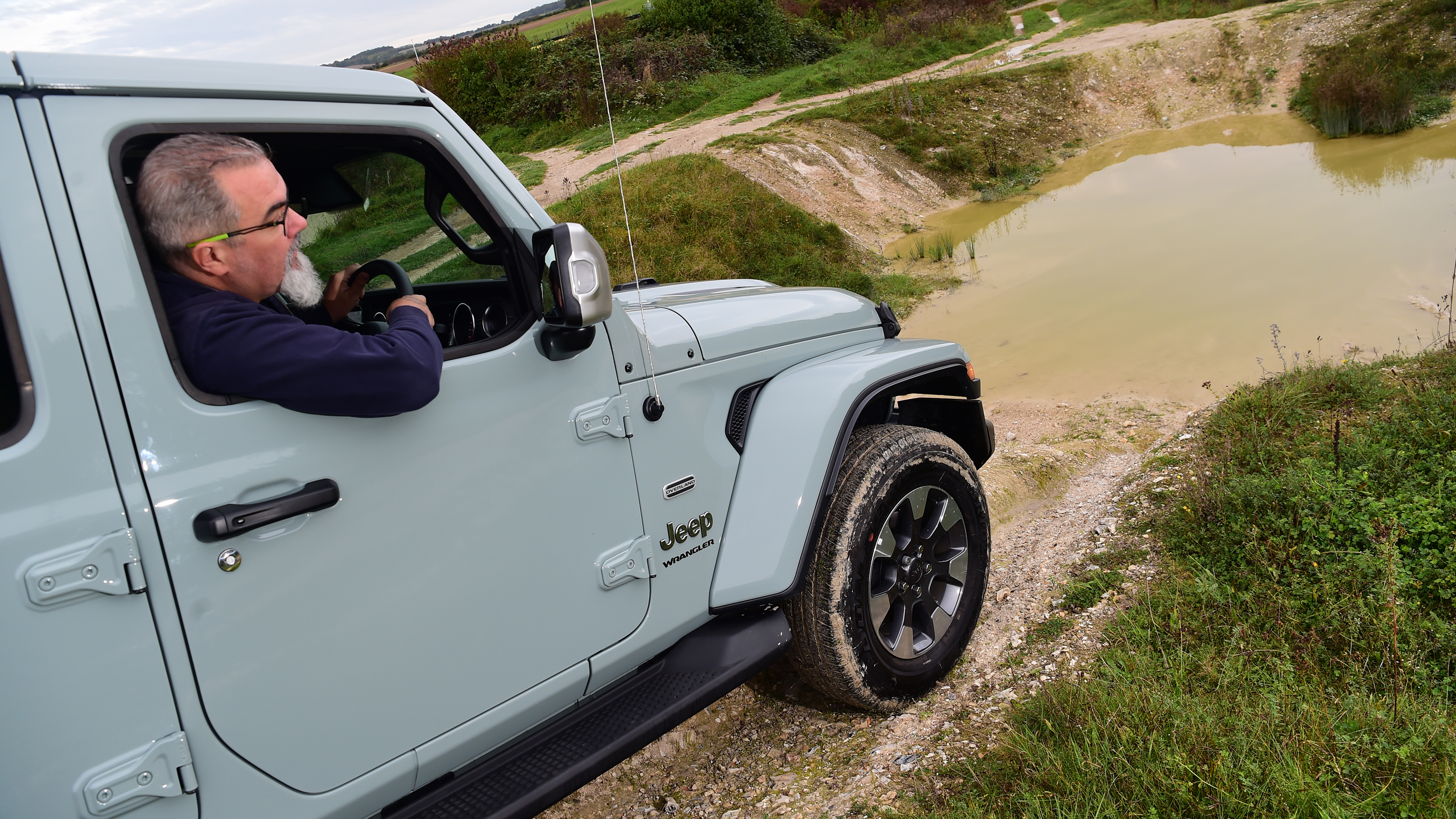 Auto Express senior test editor Dean Gibson leaning out of a Jeep Wrangler's driver's window