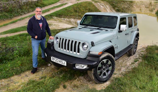 Auto Express senior test editor Dean Gibson standing next to a Jeep Wrangler