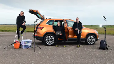 Auto Express staff photographer Pete Gibson standing in various poses next to the Skoda Karoq