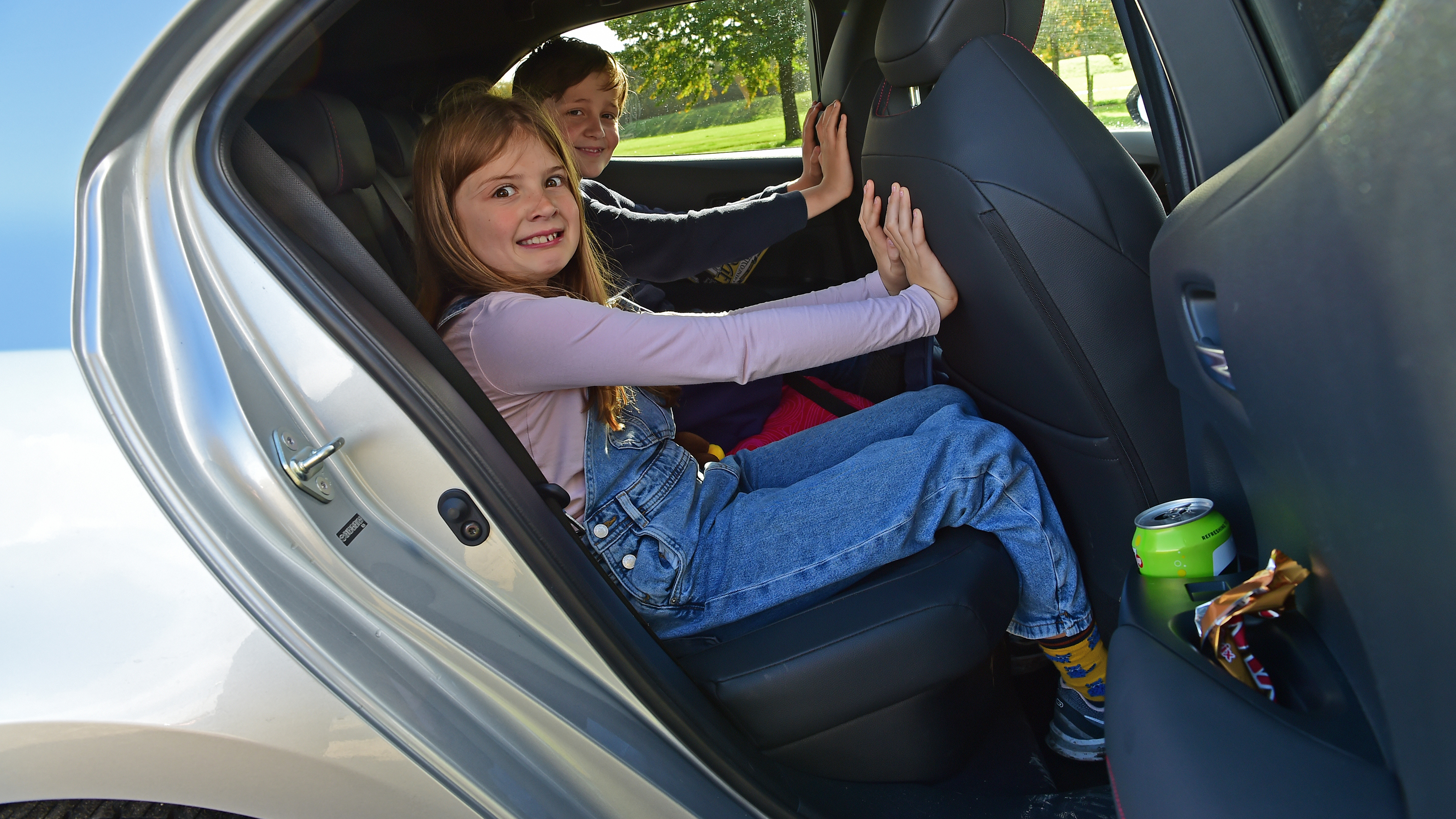 Auto Express features editor Chris Rosamond's children demonstrating the Toyota Corolla GR Sport's rear legroom