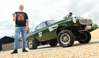 Auto Express senior test editor Dean Gibson standing next to 'Ain't no Saint' while holding its Hot Wheels replica