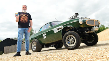 Auto Express senior test editor Dean Gibson standing next to 'Ain't no Saint' while holding its Hot Wheels replica