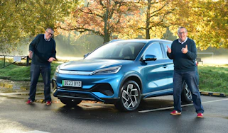 Duplicates of Auto Express editor-at-large John McIlroy standing next to the BYD Atto 3