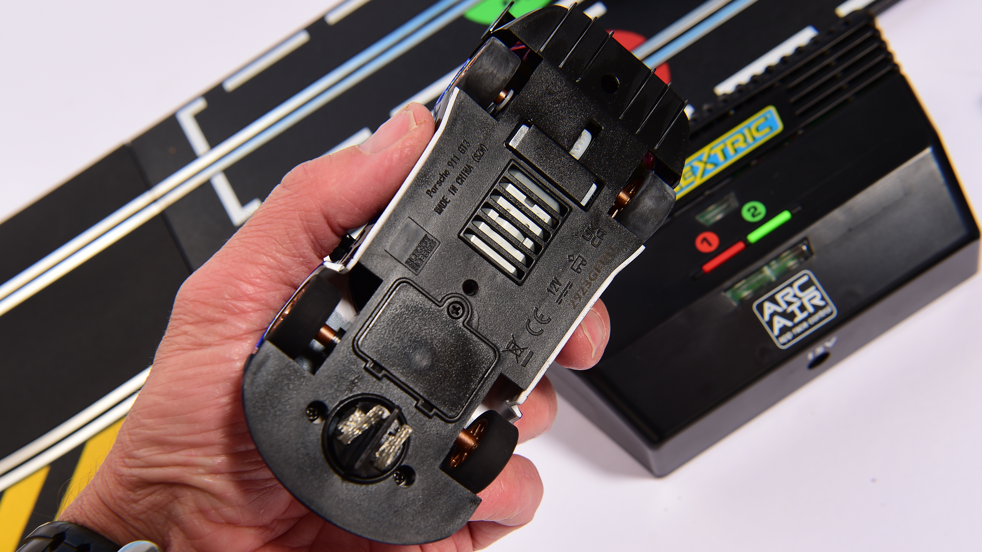 Auto Express product tester inspecting the underside of a slot car