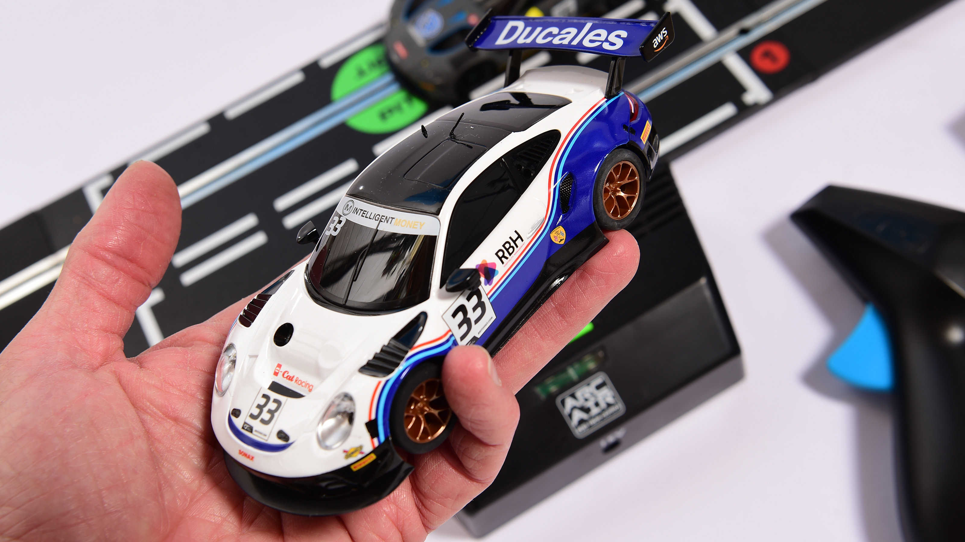 Auto Express product tester inspecting a Porsche slot car
