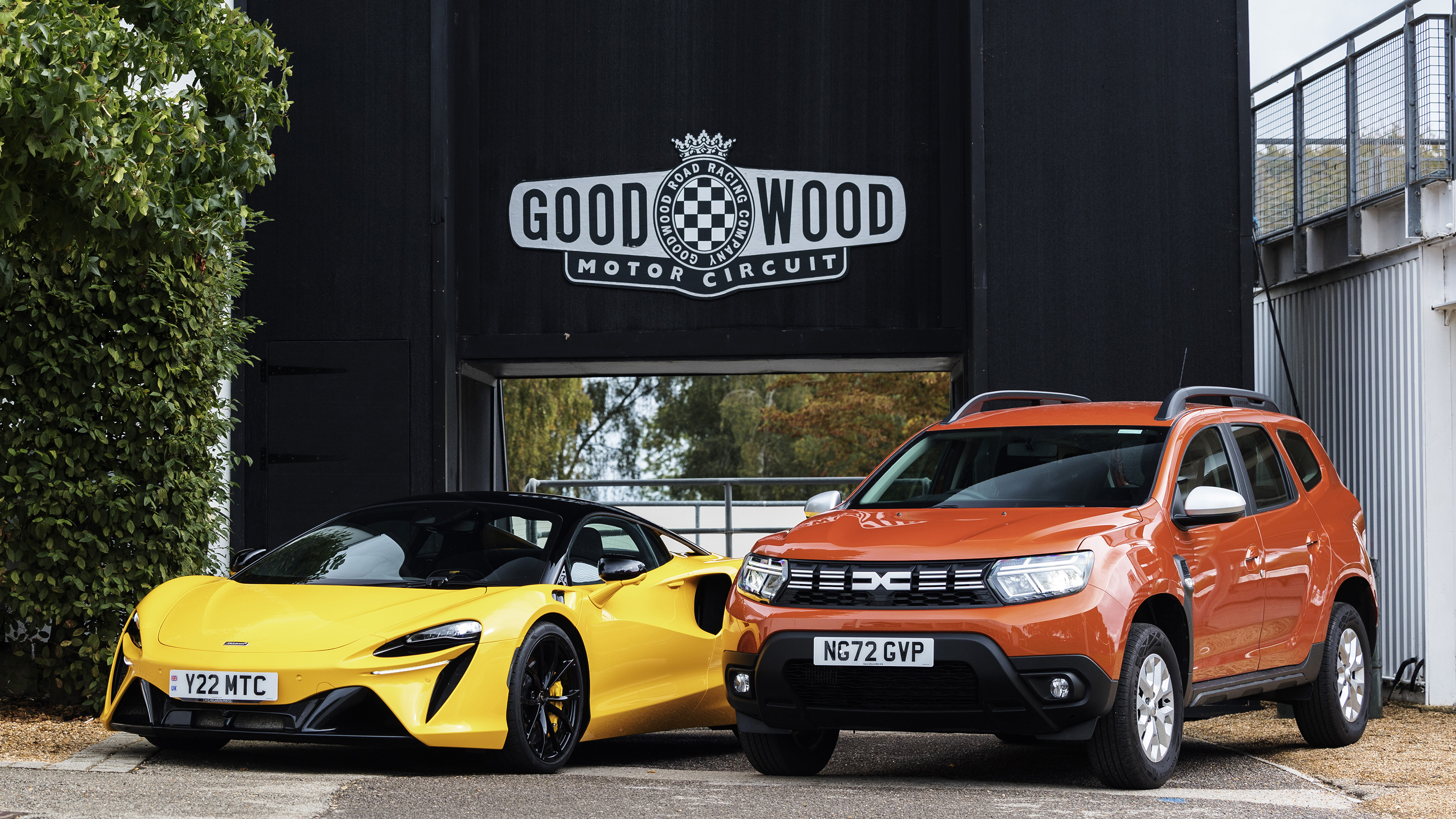 Dacia Duster and McLaren Artura outside Goodwood circuit