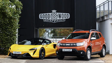 Dacia Duster and McLaren Artura outside Goodwood circuit
