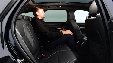 Auto Express senior news reporter Alastair Crooks sitting in the back of the Jaguar XF Sportbrake