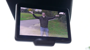 Auto Express senior test editor Dean Gibson posing on our long-term Renault Kangoo E-Tech's dash cam screen