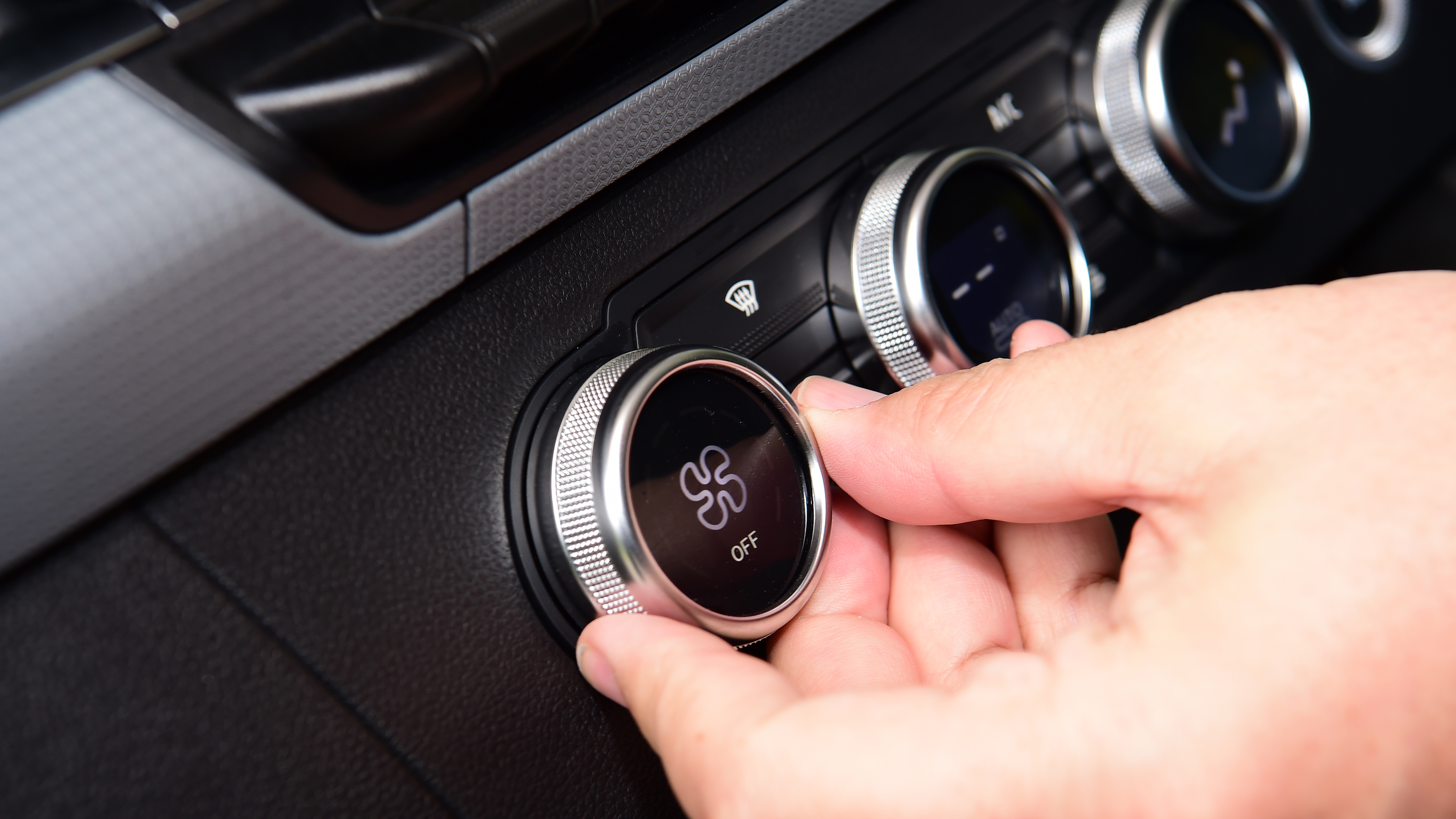 Auto Express senior test editor Dean Gibson operating our long-term Renault Kangoo E-Tech's climate controls