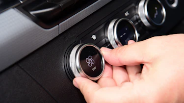 Auto Express senior test editor Dean Gibson operating our long-term Renault Kangoo E-Tech's climate controls