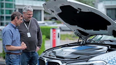 Auto Express consumer and current affairs editor Chris Rosamond inspecting a hydrogen-powered BMW
