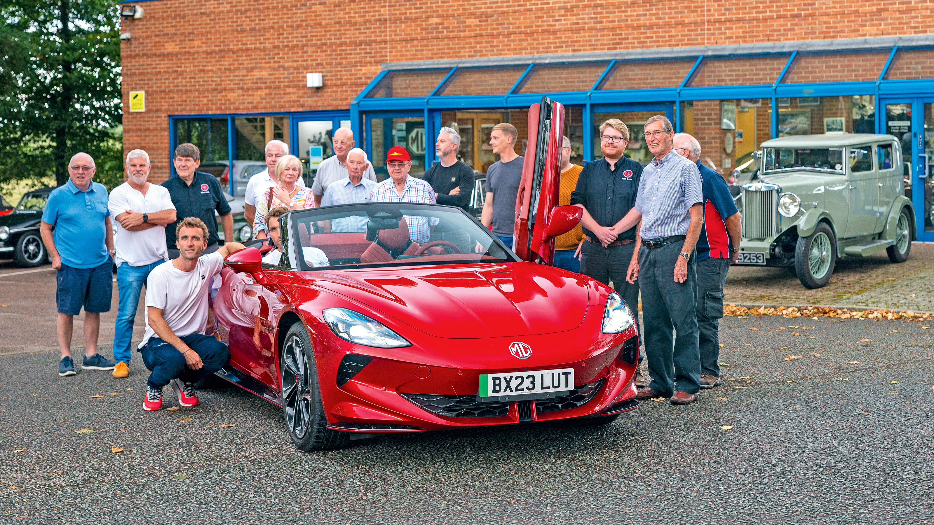 Multiple MG Owners Club members standing around the MG Cyberster