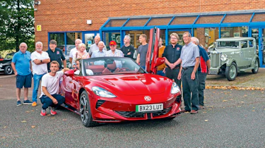 Multiple MG Owners Club members standing around the MG Cyberster