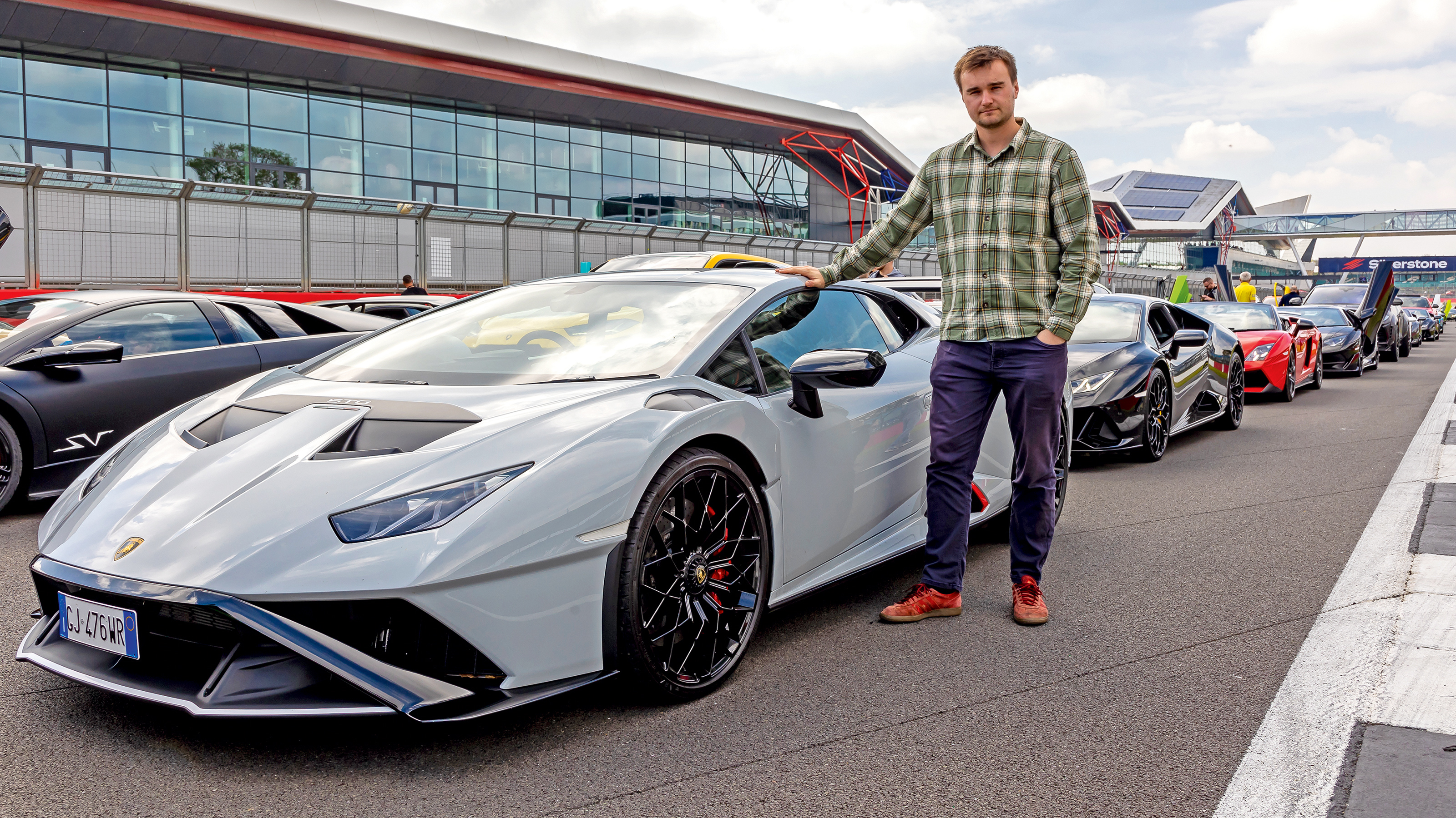 Auto Express senior news reporter Alastair Crooks standing with a Lamborghini Huracan