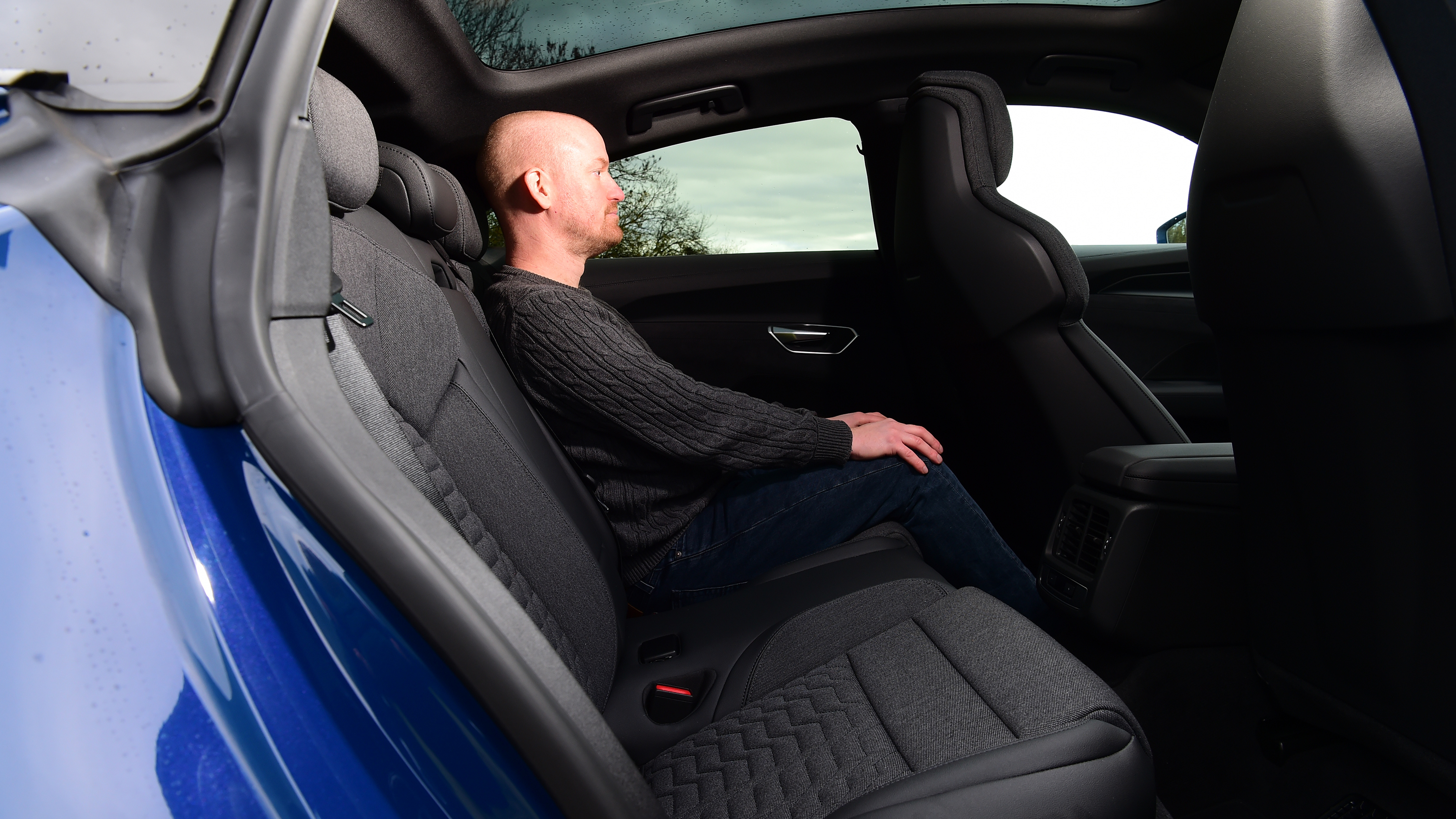 Auto Express chief reviewer Alex Ingram sitting in the back seat of the Audi RS e-tron GT