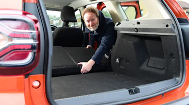 Auto Express web producer Pete Baiden folding the Dacia Duster's rear seats