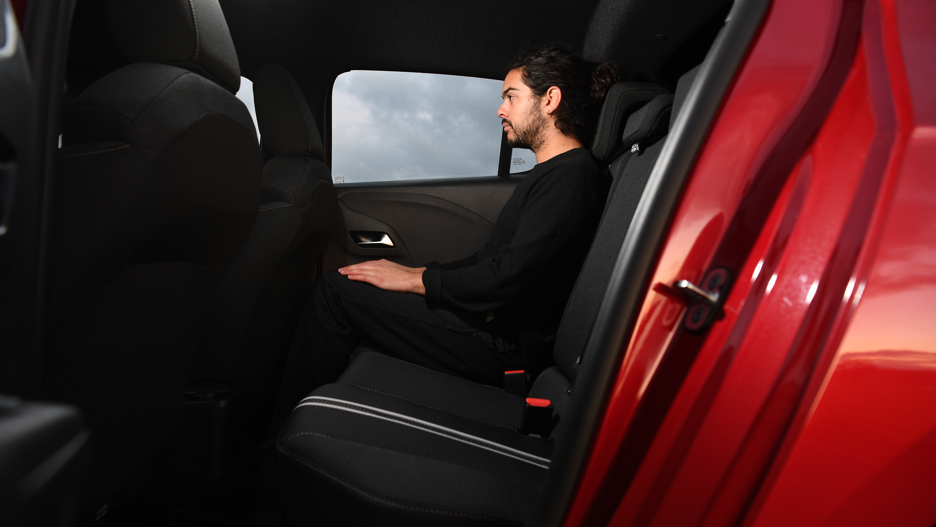 Vauxhall Corsa vs Hyundai i20 - Vauxhall raer seat with Auto Express senior staff writer Jordan Katsianisnior 