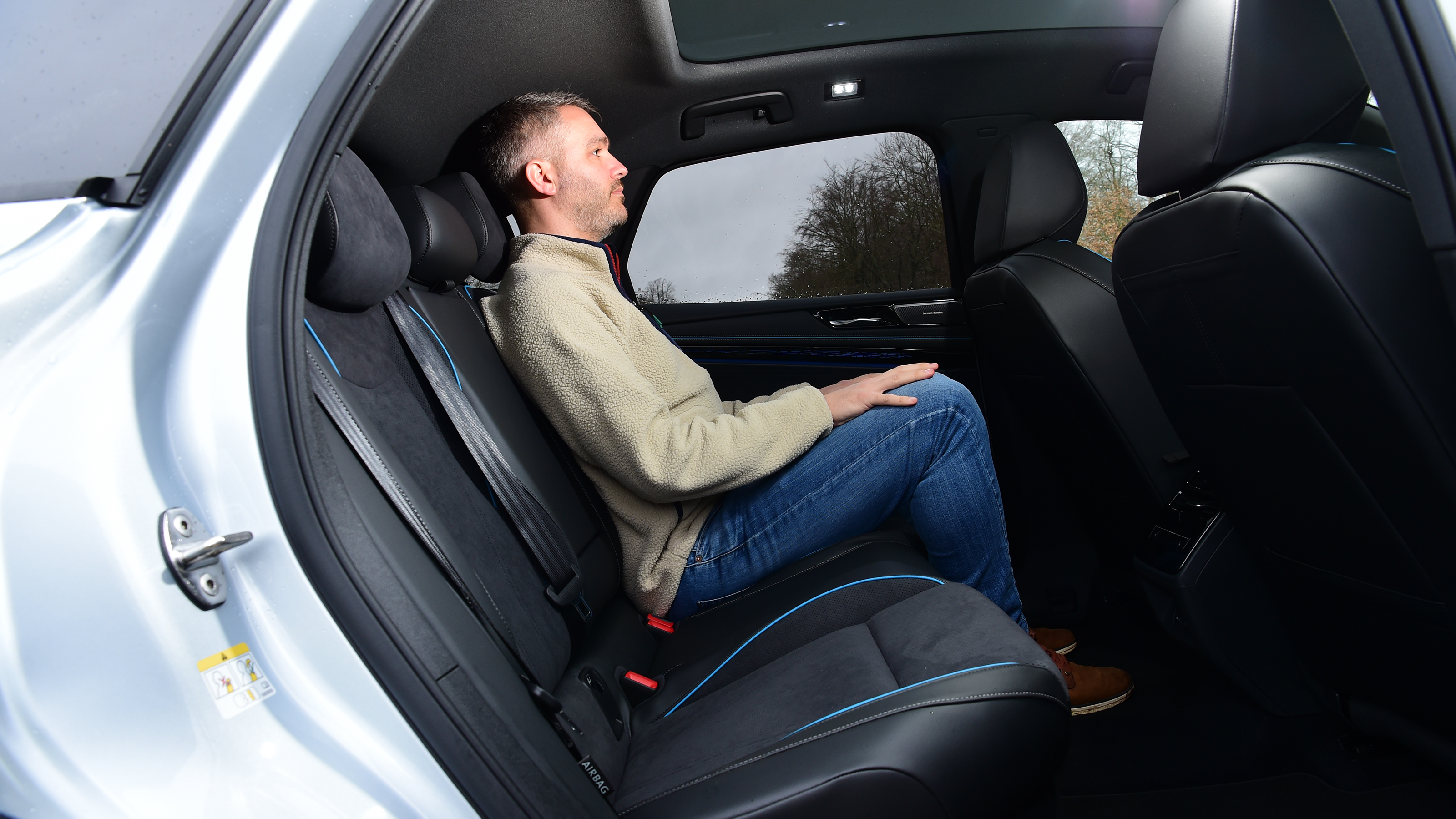 Auto Express deputy editor Richard Ingram sitting in the back seat of the Volkswagen ID.7