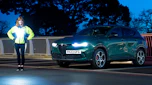 Auto Express pictures editor Dawn Grant standing next to the Alfa Romeo Tonale PHEV at night