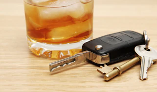 Car keys next to an alcoholic drink