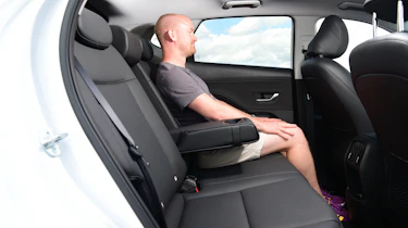 Auto Express chief reviewer Alex Ingram sitting in the Hyundai Kona's back seat