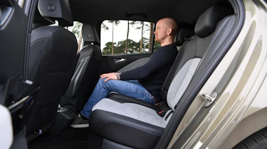 Auto Express chief reviewer Alex Ingram sitting in the Volkswagen ID.3's back seat
